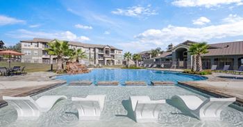 Expansive, resort style swimming pool with lounge deck and custom fountain